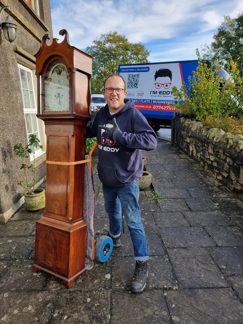 Eddy carefully moving an antique grandfather clock — single-item removals